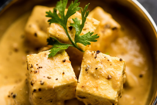 Malai or achari Paneer in a gravy made using Whipping Cream. served on a serving pan. selective focus