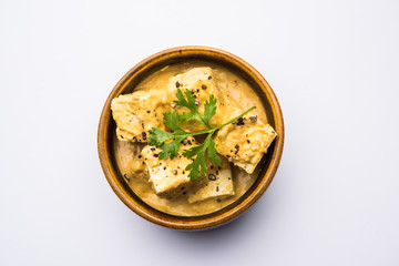 Malai or achari Paneer in a gravy made using Whipping Cream. served on a serving pan. selective focus