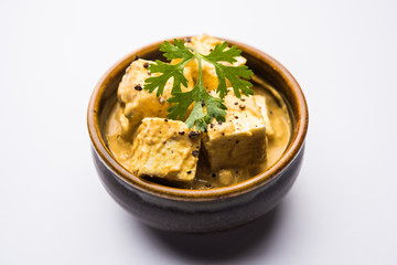 Malai or achari Paneer in a gravy made using Whipping Cream. served on a serving pan. selective focus