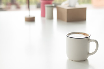 Close up a vintage cup of hot latte coffee on white vintage desk, coffee with milk