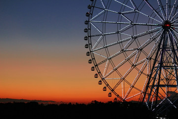 Ferris wheel in the sky of sunset