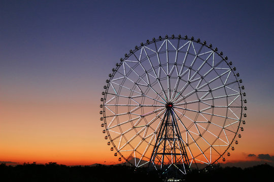 Ferris wheel in the sky of sunset