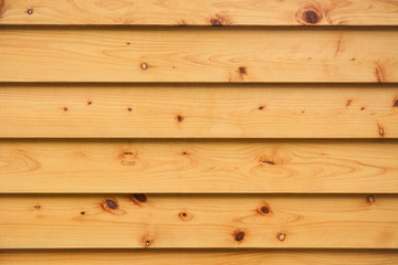 layer of horizontal natural pine wood planks strips wall background texture wide with natural eyelets and grunge