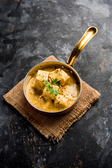 Malai or achari Paneer in a gravy made using Whipping Cream. served on a serving pan. selective focus