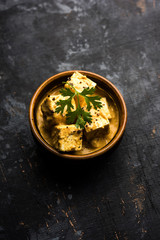 Malai or achari Paneer in a gravy made using Whipping Cream. served on a serving pan. selective focus