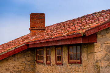 Fototapeta na wymiar roof of a rural house close up against blue sky