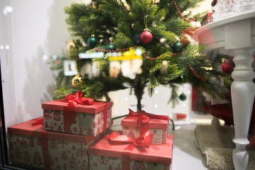 Decorated christmas tree near store window. Shallow depth of field