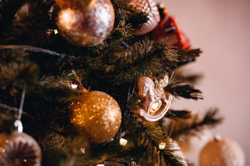 Dark Christmas background, closeup New Year ball horse on tree.