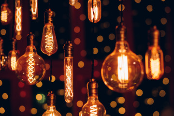 Set edison retro lamp on dark bokeh background of different shapes.