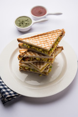 Paneer bhurji sandwich is a tasty paneer based dish made with cottage cheese.served with fresh tomato ketchup and green mint chutney. selective focus