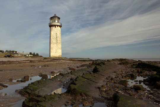 linear rock formations leading to Southerness lighthouse. Southerness, Scotland.