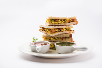 Paneer bhurji sandwich is a tasty paneer based dish made with cottage cheese.served with fresh tomato ketchup and green mint chutney. selective focus