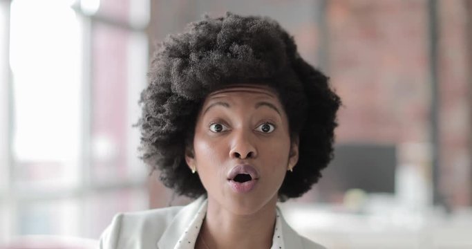 African American businesswoman talking directly to camera in an office 