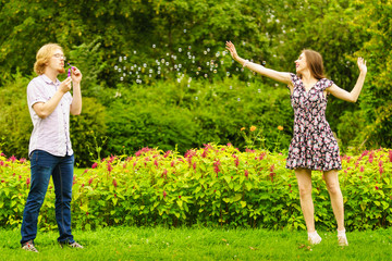 Couple blowing bubbles outdoor