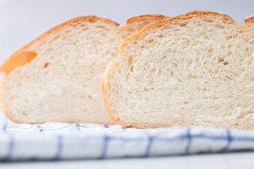 Fresh home made bread on white table background with napkin