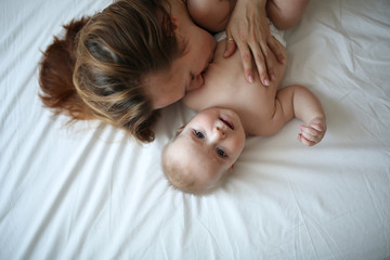 mother gently hugs son, top view, white background