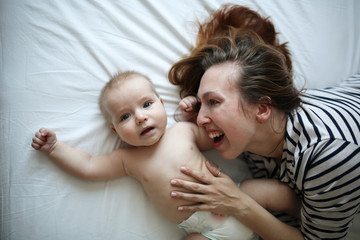 mother gently hugs son, top view, white background