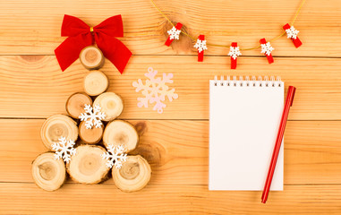 Wooden Christmas tree with bow and snowflakes.
