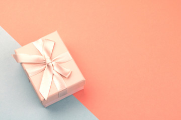 Pink gift box with bow with copyspace.