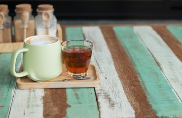 Close up a vintage cup of hot latte coffee on wooden vintage desk, coffee with milk