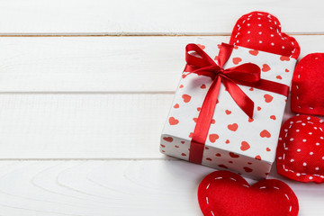Valentine or other holiday handmade present in paper with red hearts and gifts box in holiday...