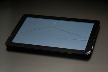 The broken screen of the tablet, close-up on a black background