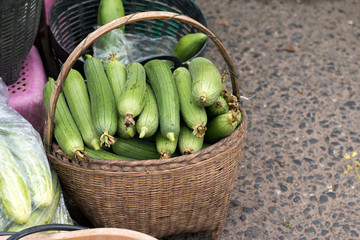Sponge Gourd on bamboo basket at vintage Roi-Et market in Thailand