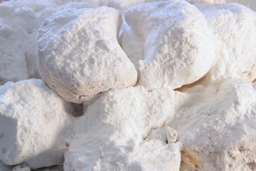 Close up of qurabiya or kourambiethes an almond flavoured crisp buns similar to macaroons a Greek traditional christmas dessert with powdered sugar