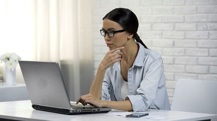 Asian woman giving professional consultations online, thinking about answer