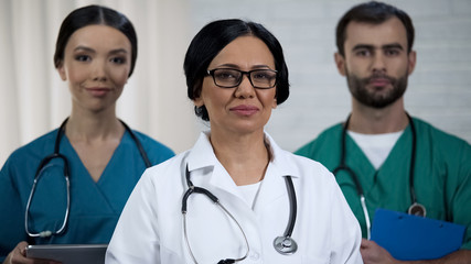 Fototapeta premium High-qualified surgeon, nurses ready to help patients, professional medical team