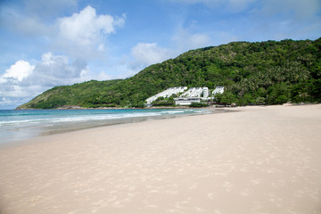 Fototapeta na wymiar large sandy beach in phuket with blue sea and jungle