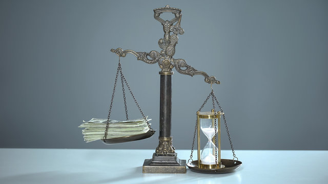 Sandglass outweighs dollar banknotes, time management, valuable resources usage