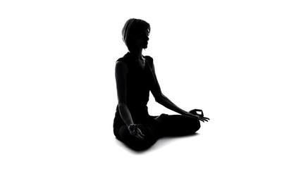 Woman sitting in lotus pose and meditating, finding yoga peace, namaste gesture