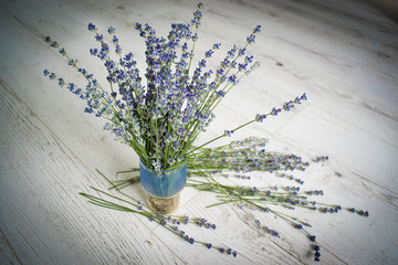 Country still life in the style of boho, old wooden board and a bouquet of lavender