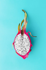 Fresh organic dragon fruit on a blue background, creative summer food concept