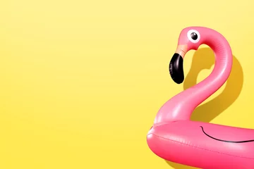 Gordijnen Reuze opblaasbare Flamingo op een gele achtergrond, pool float party, trendy zomerconcept © SEE D JAN