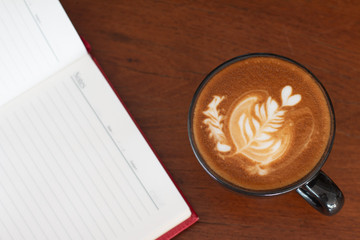 A cup of Piccolo Latte art  on wooden desk, Relaxing time or coffee's break time during work day