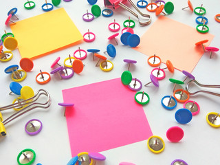 Colorful stationary, back to school, office, business and education concept. School and office supplies paper clips, pins, notes, stickers on white background. Mock up. Close up photography
