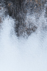Close-up of snow and some rock in the winter, viewed from above.
