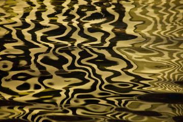 Waves on water create freakish diffractional structures similar to velvet on its surface, yellow ...