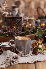 Fragrant coffee, chocolates in the form of Christmas figures. Cookies and hot drink for the holiday. Cozy atmosphere, candles decor. free space for text.