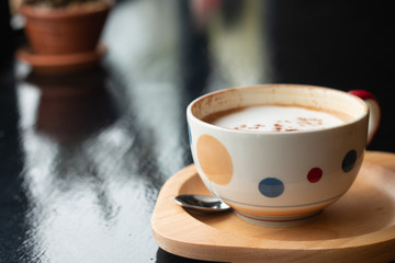 A cup of Latte coffee on wooden desk, Relaxing time or coffee's break time during work day