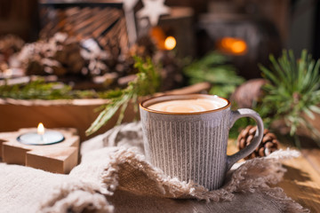 Fresh aromatic coffee and Christmas decor. Cozy festive atmosphere with candles and drinks. Free space for text.
