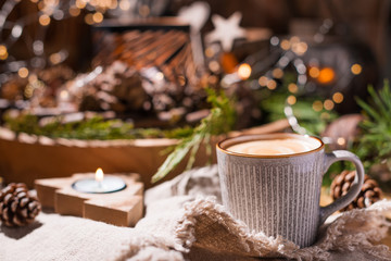 Fresh aromatic coffee and Christmas decor. Cozy festive atmosphere with candles and drinks. Free space for text.