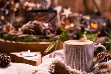Obraz na płótnie Canvas Fresh aromatic coffee and Christmas decor. Cozy festive atmosphere with candles and drinks. Free space for text.