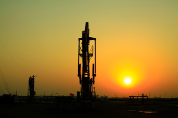 Crank balanced beam pumping unit in Jidong oilfield sunset scenery, closeup of photo