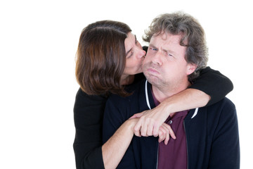 woman in a couple embraces her man who makes a fun grin with her long hair fashion