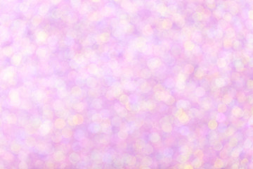 Blurred shiny pink background with sparkling lights.