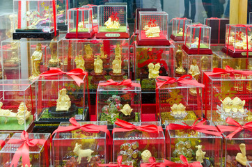 A shop window front full of golden cat statues
