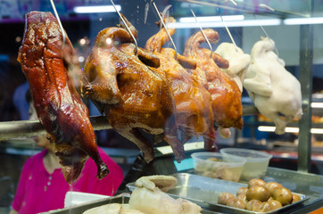 A row of roasted hainanese ducks in Asian street food market
